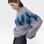 JONES + CO fleecy alpaca blend raglan pullover in grey with a blue peacock intarsia graphic pattern on the chest.