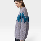 JONES + CO fleecy alpaca blend raglan pullover in grey with a blue intarsia graphic pattern worn by a model