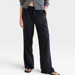JONES + CO Joanna wool trousers in anthracite with a relaxed wide-leg fit and elastic waistband on a model