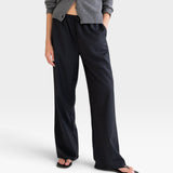 JONES + CO Joanna wool trousers in anthracite with a relaxed wide-leg fit and elastic waistband on a model