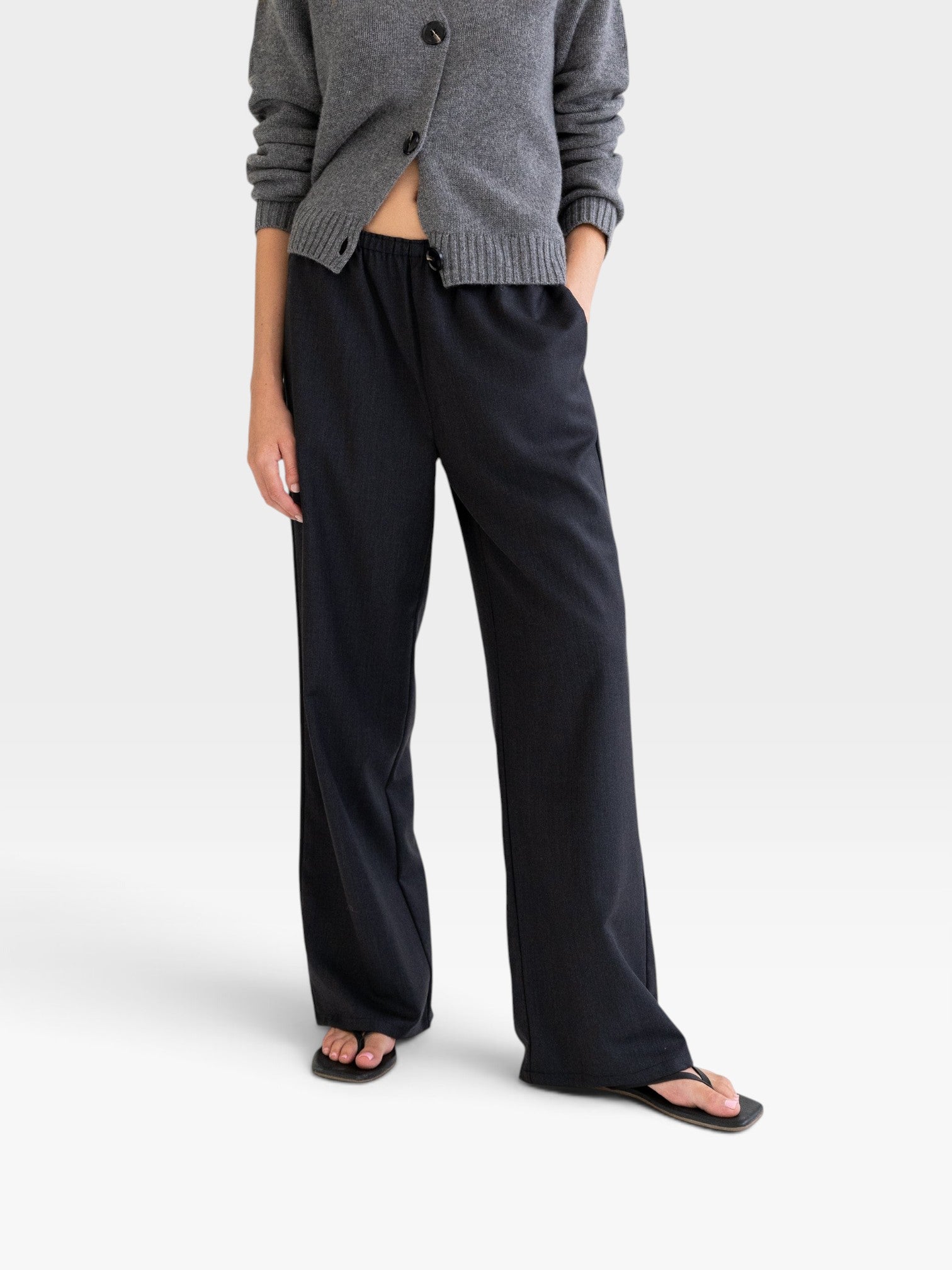 JONES + CO Joanna wool trousers in anthracite with a relaxed wide-leg fit and elastic waistband on a model