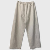 JONES + CO Arc pants in naturel heavy-weight canvas with an elastic high waist and curved leg silhouette.