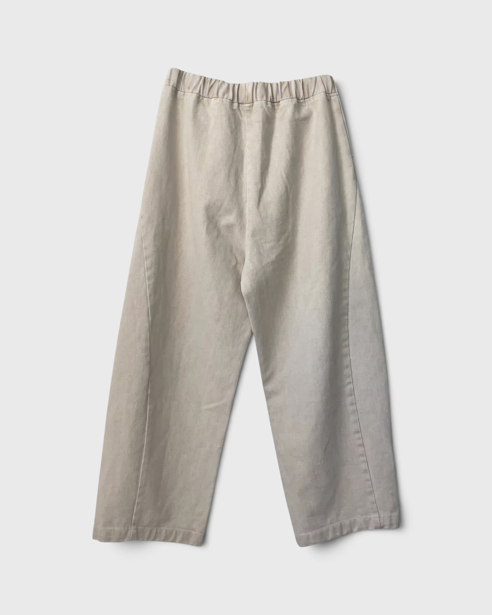 JONES + CO Arc pants in naturel heavy-weight canvas with an elastic high waist and curved leg silhouette.