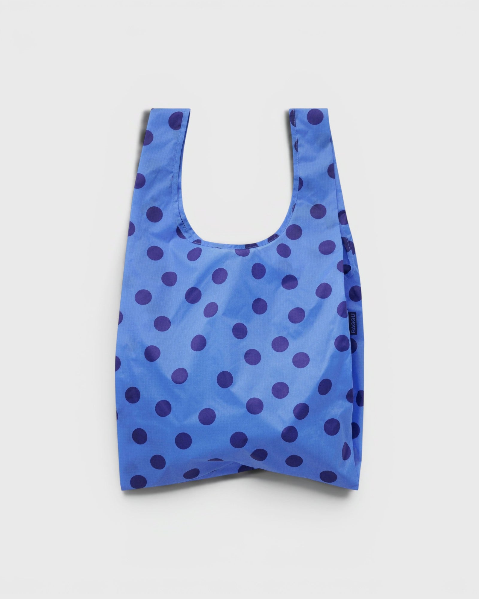 JONES + CO Baggu reusable tote in blue ripstop nylon with a dark blue polka dot pattern