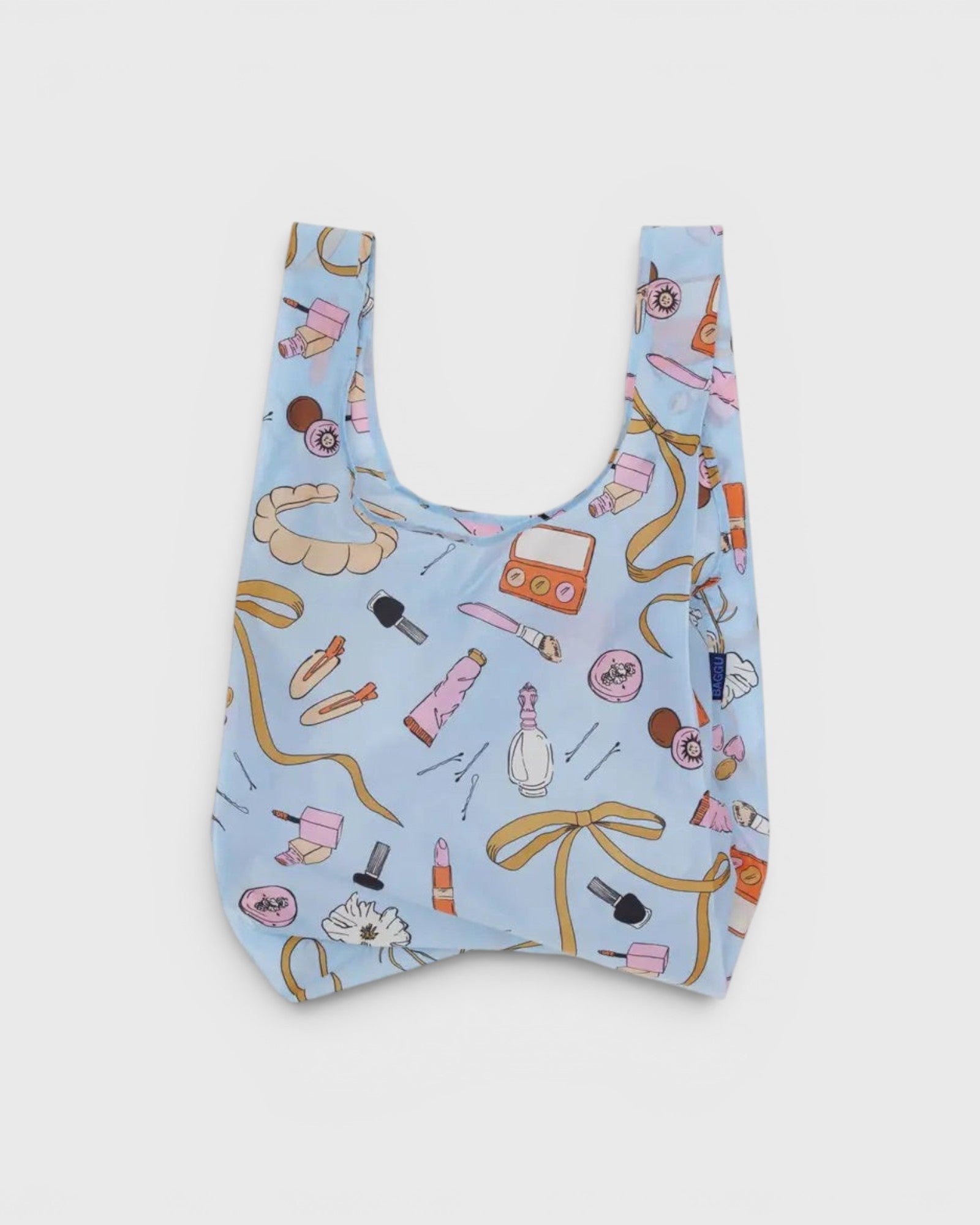 JONES + CO Baggu reusable grocery bag in light blue ripstop nylon with a Get Ready With Me makeup and accessory print