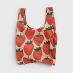 JONES + CO Baggu reusable tote bag in beige with a red and green strawberry print made from lightweight nylon