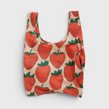 JONES + CO Baggu reusable tote bag in beige with a red and green strawberry print made from lightweight nylon