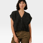 Model wearing a JONES + CO basalt grey cropped button-front vest in a soft alpaca and merino wool blend.