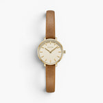 JONES + CO Beverly watch featuring a gold case, cream dial, and slim brown leather strap on a white background.