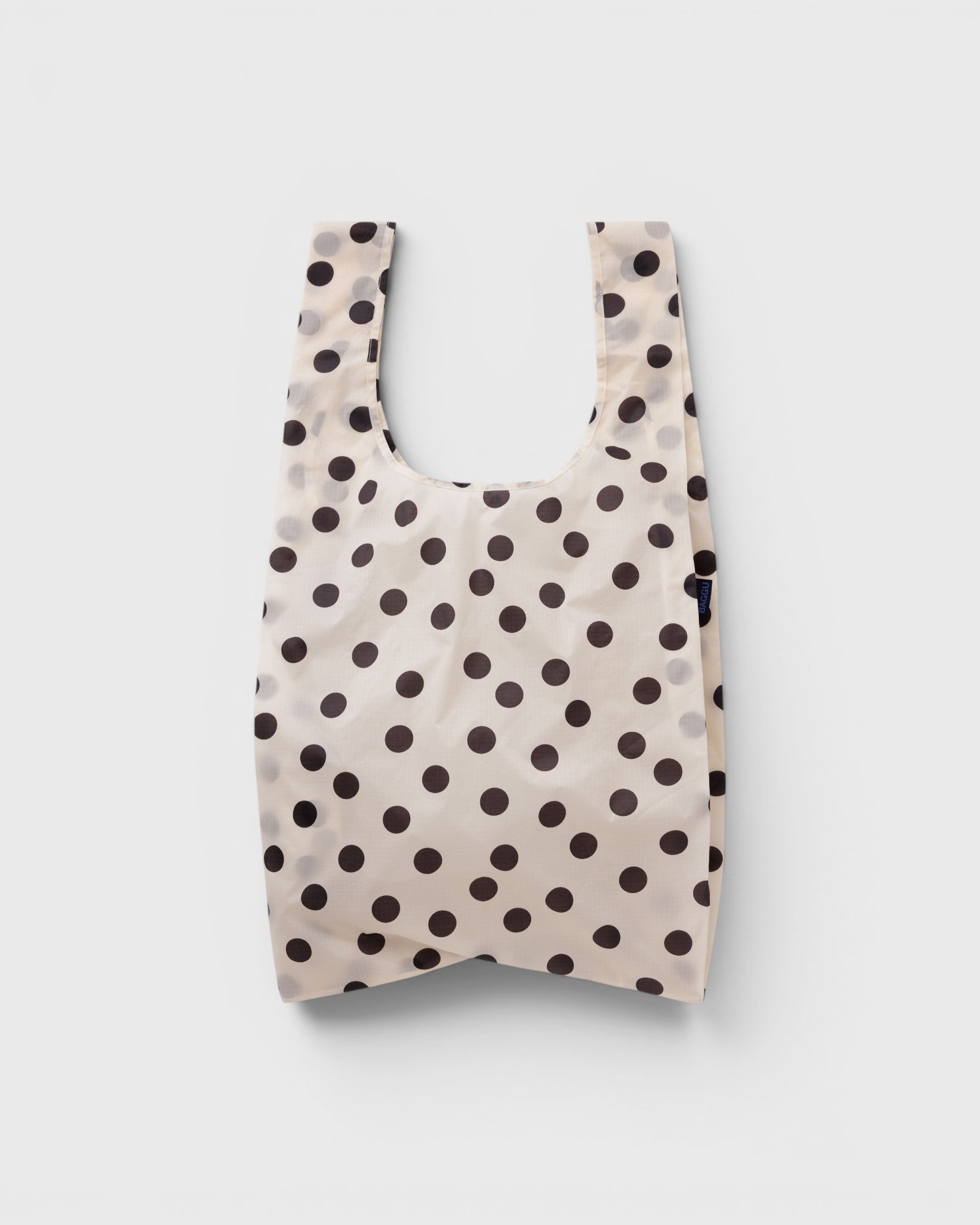 JONES + CO Big Baggu reusable tote in cream with black polka dot pattern, perfect for groceries or beach trips.