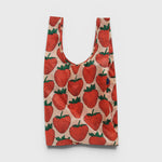 JONES + CO Big Baggu reusable tote bag in a light pink fabric with a red and green strawberry print pattern.