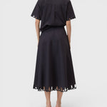 JONES + CO black midi skirt with cut-out embroidery hem, worn with matching short-sleeve shirt, back view