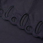 JONES + CO black midi skirt featuring intricate cut-out embroidery along the scalloped hemline.