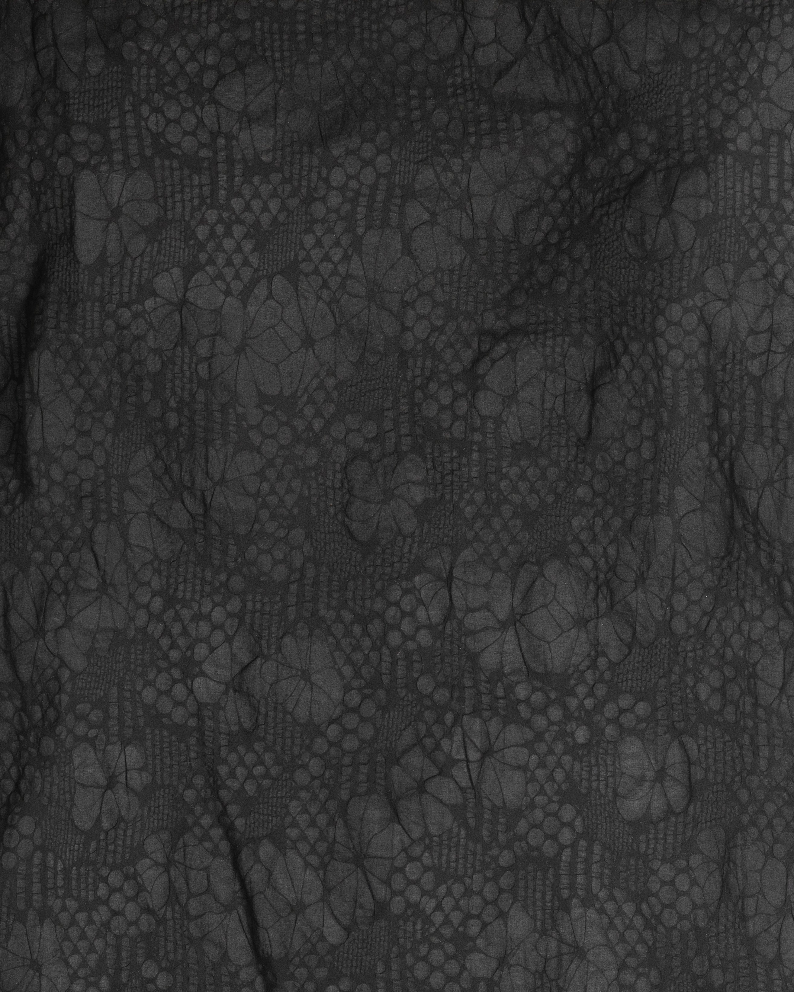 JONES + CO Pinch Shift dress fabric featuring a black embossed floral pattern with a textured seersucker effect.