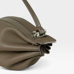 JONES + CO Bon-Bon taupe leather handbag featuring pleated ends, silver metal clasp, and adjustable shoulder strap.