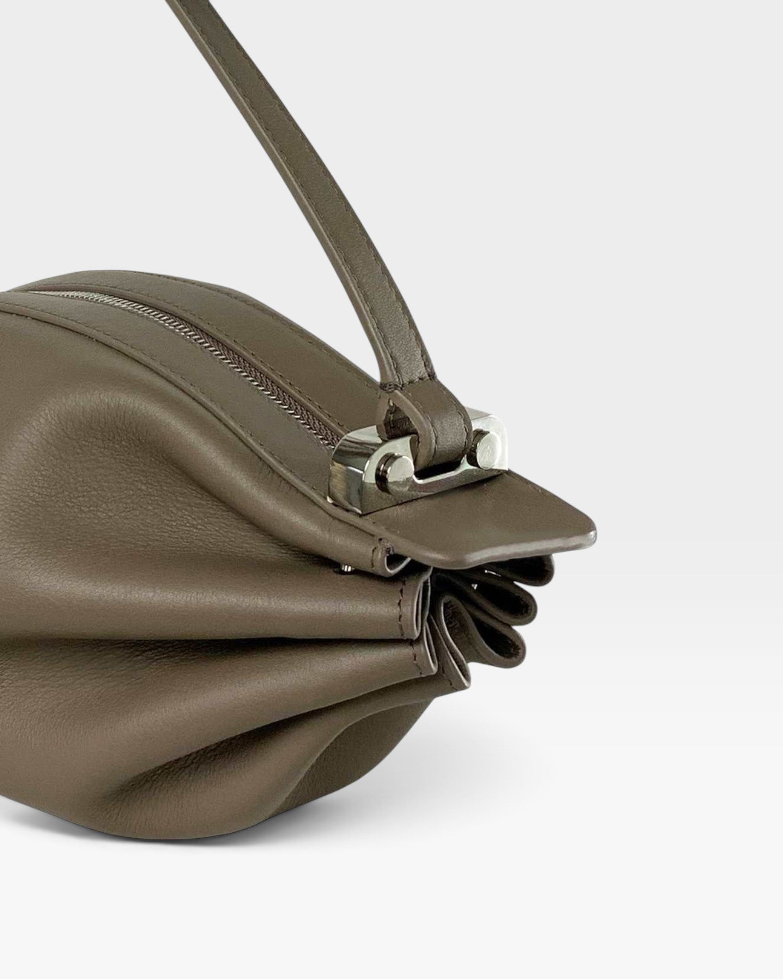JONES + CO Bon-Bon taupe leather handbag featuring pleated ends, silver metal clasp, and adjustable shoulder strap.
