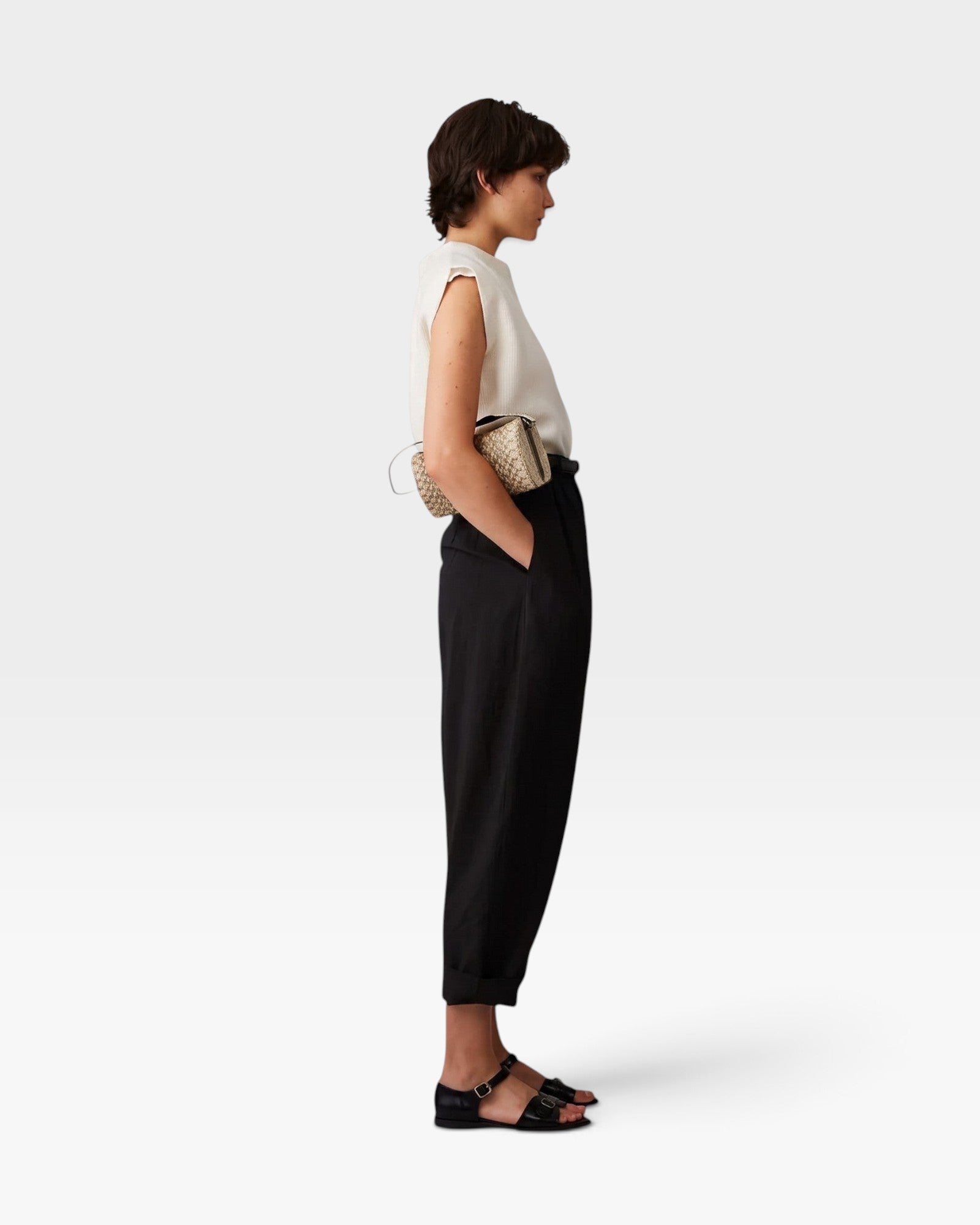 JONES + CO Brady black wool trousers with a high-waisted, tapered, cropped fit worn by a model in profile view.