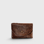 JONES + CO brown cowhide hair-on-hide cardholder with a solid brass fastener, front view.