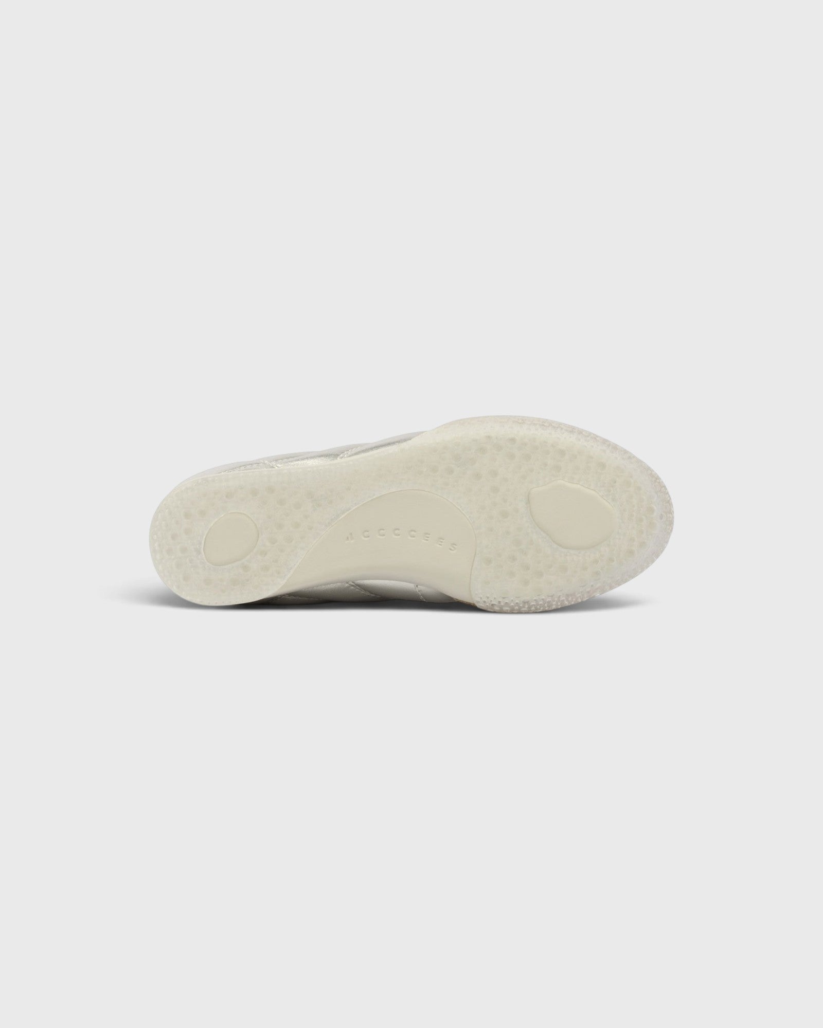 JONES + CO Bubble Ollo sneaker in champagne metallic leather with a translucent, textured bubble-effect outsole.