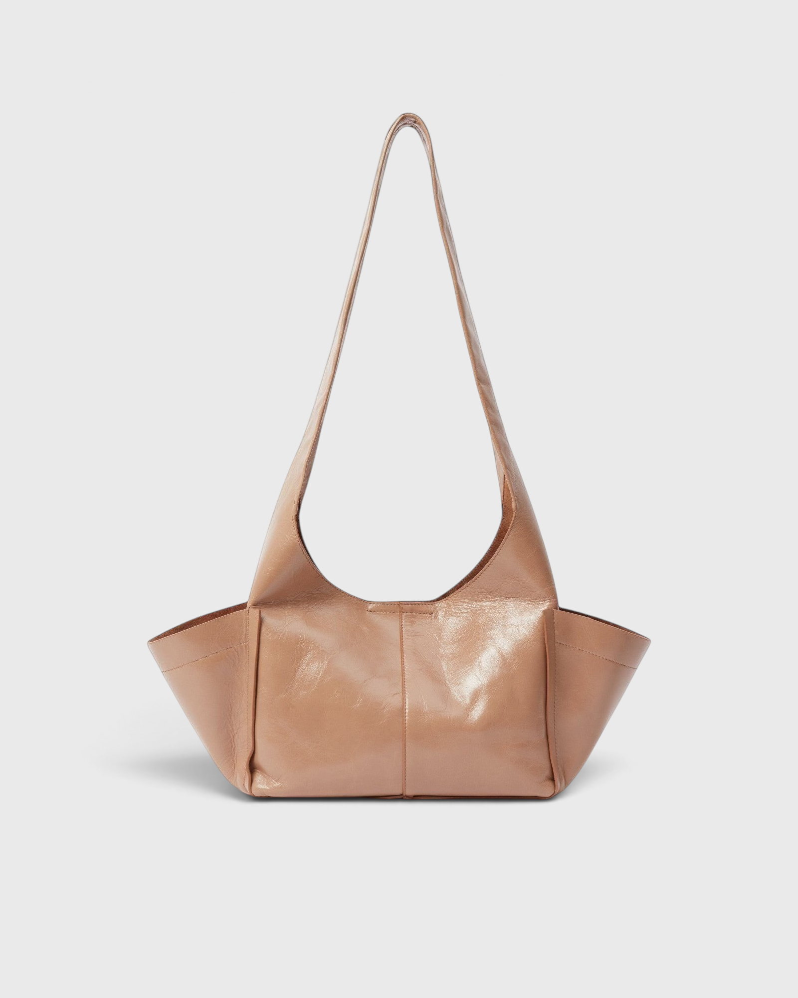JONES + CO camel leather Tool Bag with a sculptural silhouette, fixed shoulder strap, and extended side pockets.