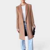 JONES + CO camel wool cashmere tailored coat with notch collar worn by a model with light wash jeans and boots