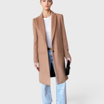 JONES + CO camel wool cashmere tailored coat with notch collar worn by a model with light wash jeans and boots
