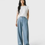 JONES + CO Coxsone Pant in Celeste blue, a high-waisted wide-leg pleated trouser in organic cotton on a model.