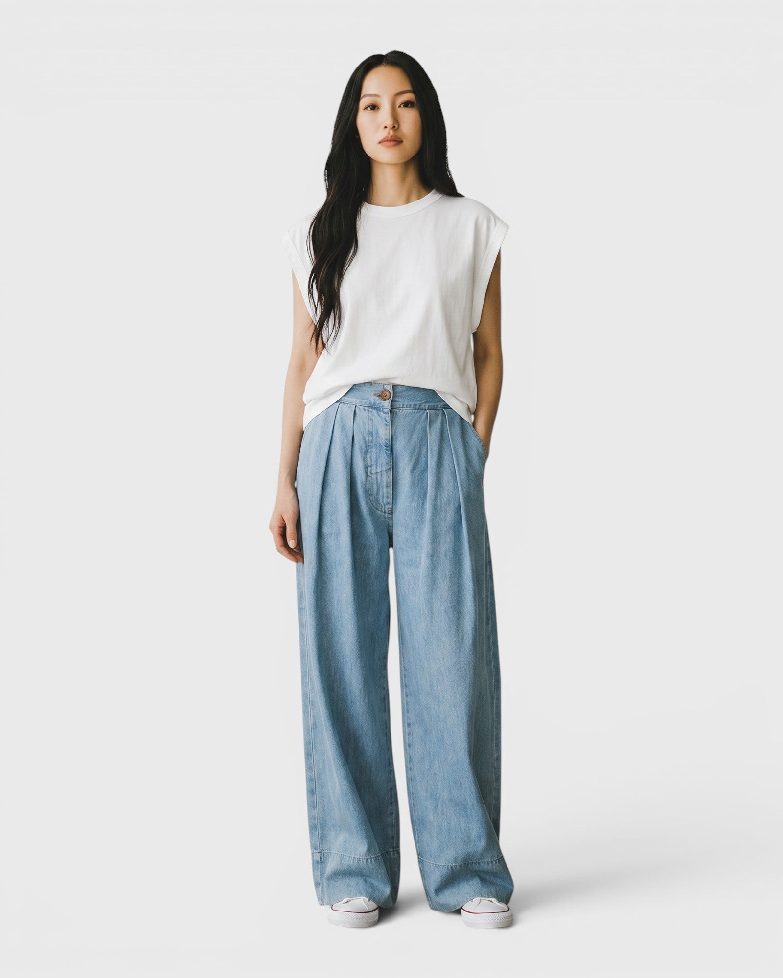 JONES + CO Coxsone Pant in Celeste blue, a high-waisted wide-leg pleated trouser in organic cotton on a model.