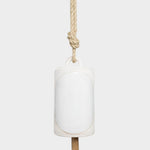 JONES + CO Thrown Bell in Domino Indigo, a white ceramic hanging bell with a rustic rope and wooden clapper.