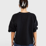 JONES + CO Rachel Comey charcoal Fond sweatshirt with drop shoulders and raw edge hem, back view on a model.