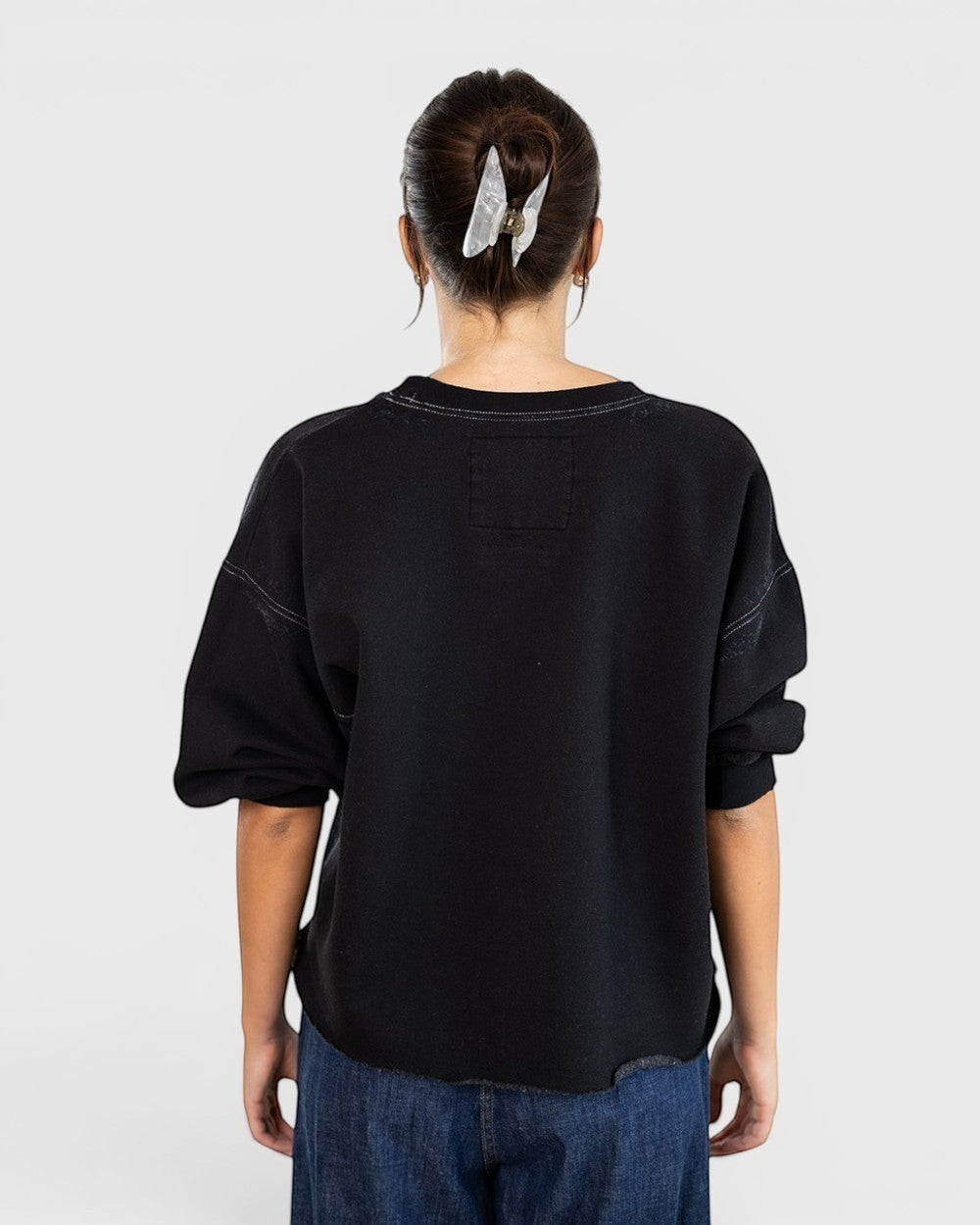 JONES + CO Rachel Comey charcoal Fond sweatshirt with drop shoulders and raw edge hem, back view on a model.
