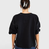 JONES + CO Rachel Comey charcoal Fond sweatshirt with drop shoulders and raw edge hem, back view on a model.