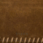 JONES + CO Harlow Bag in cigar brown suede featuring decorative leather whipstitch edging and embossed logo detail.