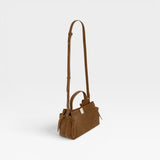 JONES + CO Gyoza Mini handbag in cognac suede with gold-tone hardware and adjustable shoulder strap, side view.