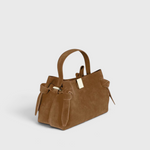 JONES + CO Gyoza Mini handbag in cognac suede with a top handle, knotted side details, and gold-tone hardware.
