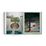 JONES + CO Courtyard Homes book open to a spread showing contemporary concrete architecture with circular courtyards.