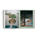 JONES + CO Courtyard Homes book open to a spread showing contemporary concrete architecture with circular courtyards.