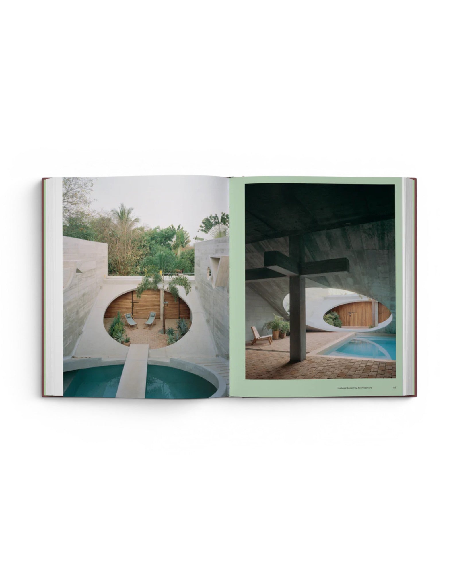JONES + CO Courtyard Homes book open to a spread showing contemporary concrete architecture with circular courtyards.