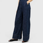 JONES + CO Coxsone high-waisted wide-leg trousers in dark indigo washed denim with pleated front detail