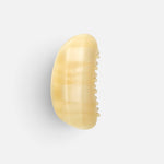 JONES + CO crescent-shaped hair claw clip in a translucent citrine yellow resin with a smooth contoured finish.