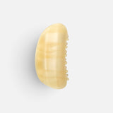 JONES + CO crescent-shaped hair claw clip in a translucent citrine yellow resin with a smooth contoured finish.