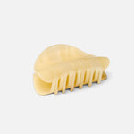 JONES + CO crescent-shaped hair claw clip in a translucent citrine yellow finish with a smooth, contoured design.