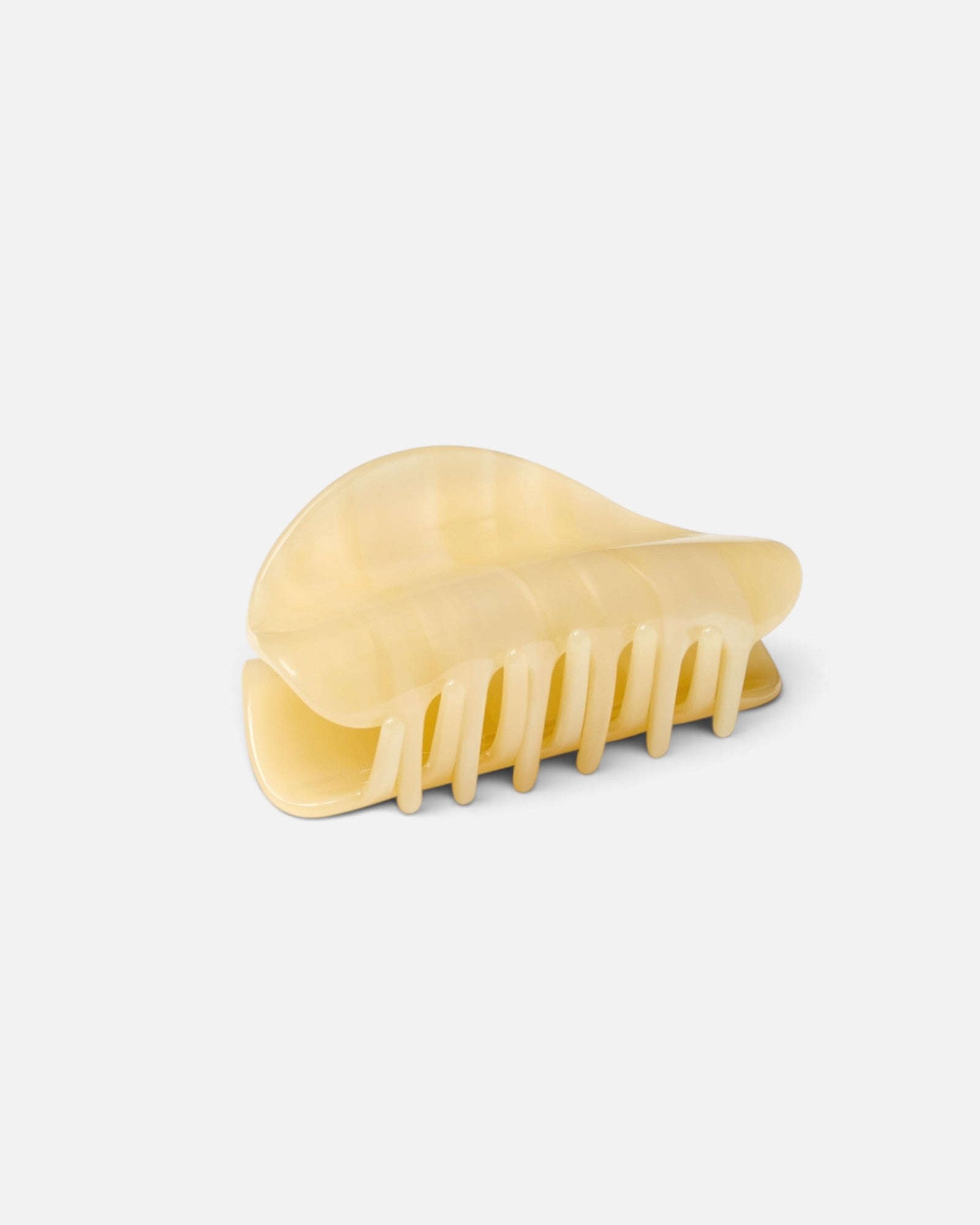 JONES + CO crescent-shaped hair claw clip in a translucent citrine yellow finish with a smooth, contoured design.