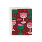 JONES + CO Crystal Cheers greeting card featuring pink and green cocktail glass illustrations on a dark red background