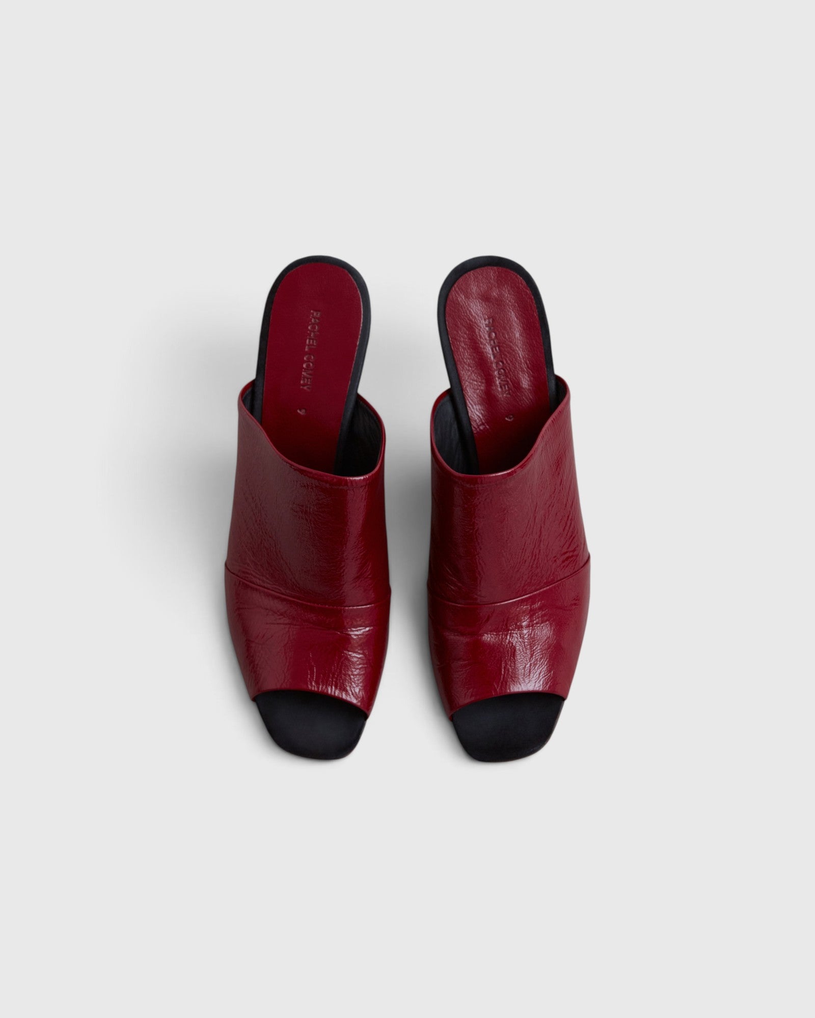 JONES + CO Rachel Comey Dahl scarlet leather sculptural wedge mules with an angular peep toe and slip-on design.