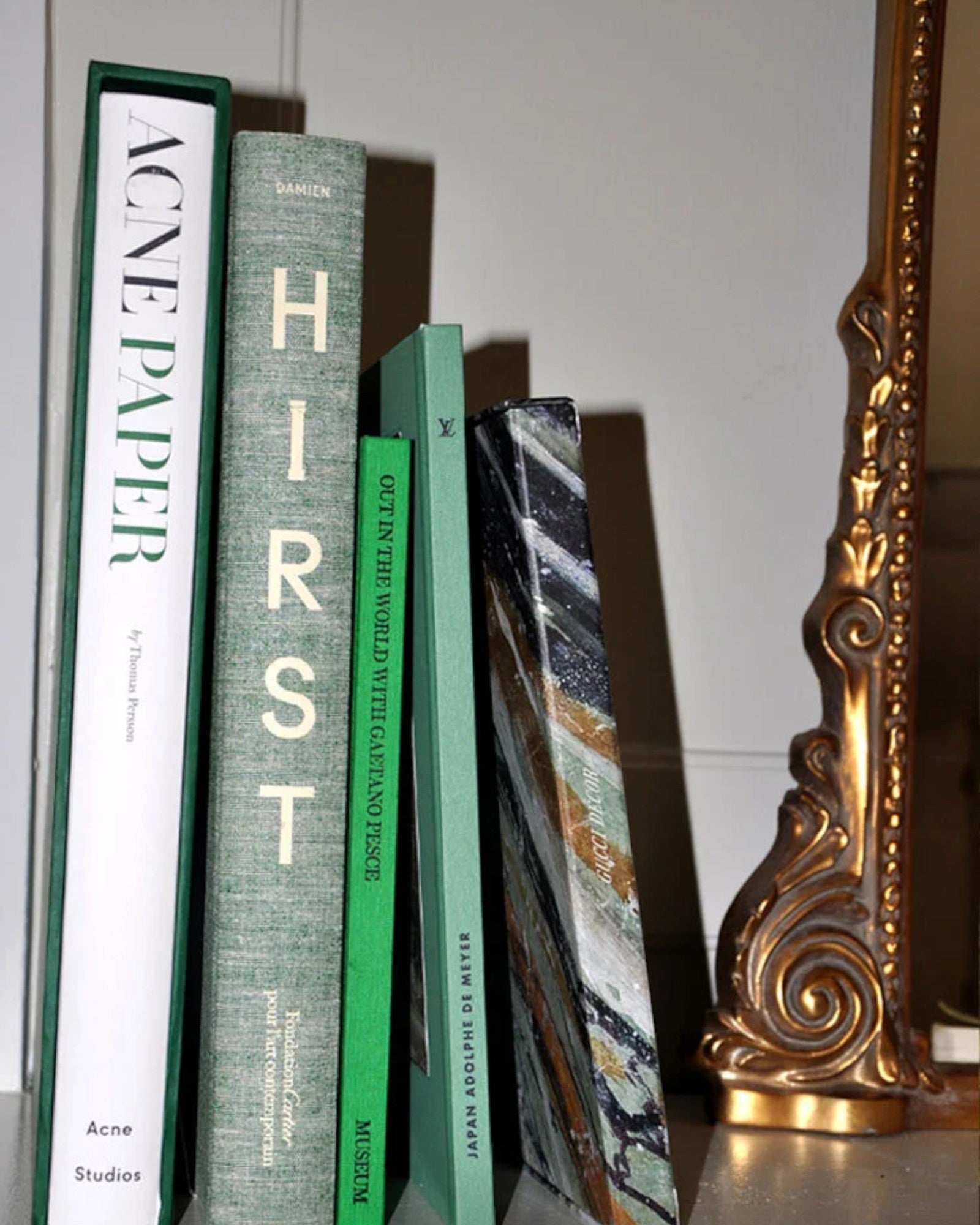 JONES + CO collection featuring Damien Hirst Cherry Blossoms art book alongside Acne Paper and other decorative books.