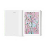 JONES + CO art book open to a page featuring Damien Hirst's vibrant pink and blue Cherry Blossoms painting