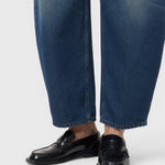 JONES + CO Jazzie barrel jeans in dark blue denim with a cropped leg, paired with black leather loafers.