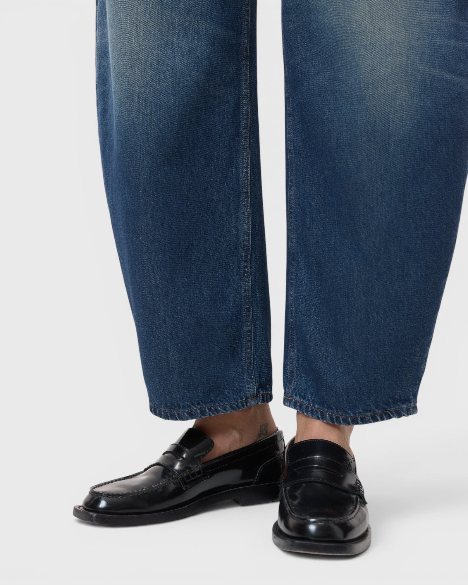 JONES + CO Jazzie barrel jeans in dark blue denim with a cropped leg, paired with black leather loafers.