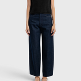 JONES + CO dark indigo high-rise relaxed-fit jeans with outseam piecing and a rounded leg shape on a model.